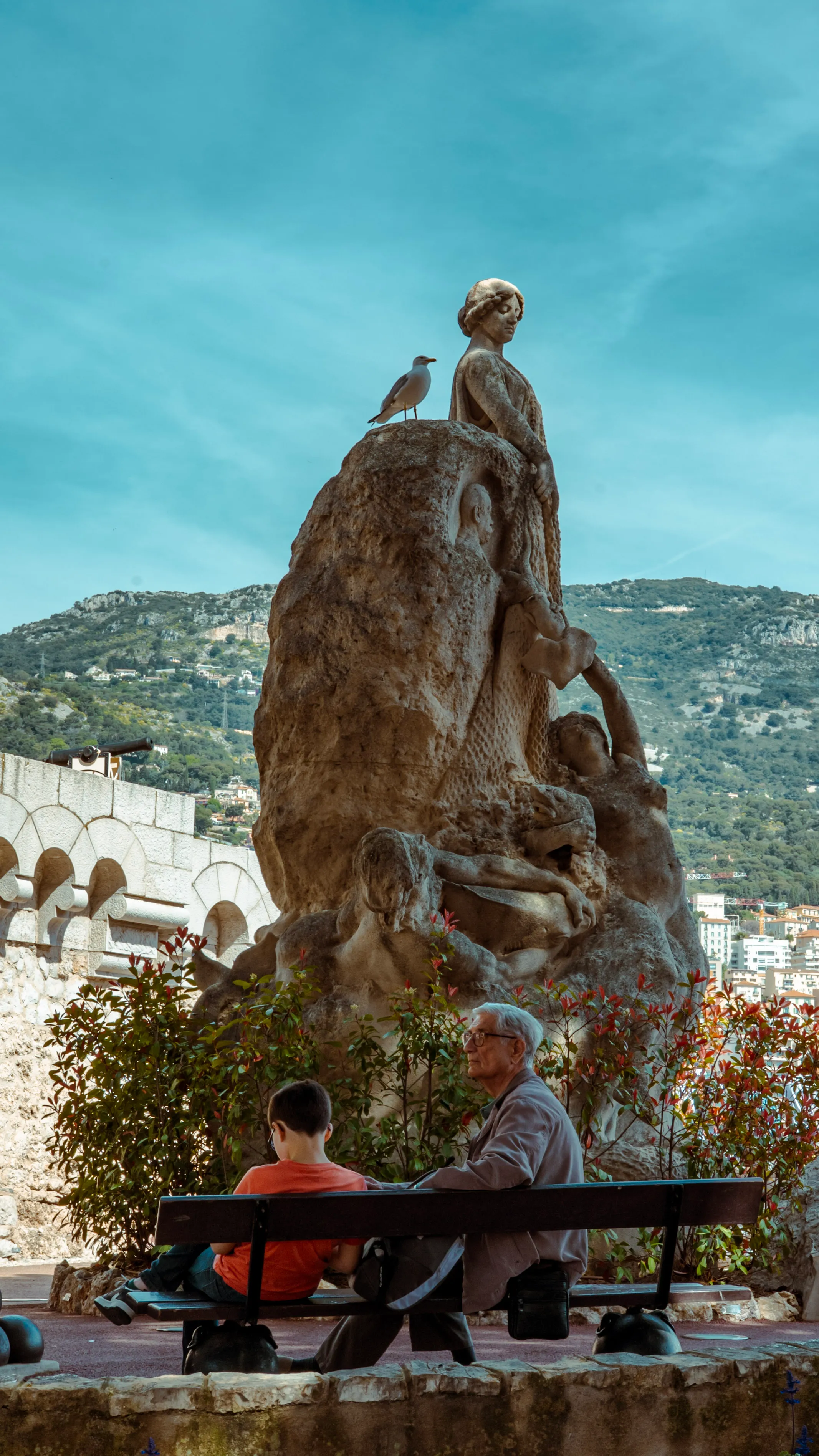 Grand-père et petit-fils sous la statue